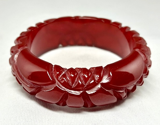 BB434 translucent cranberry flower carved bakelite bangle